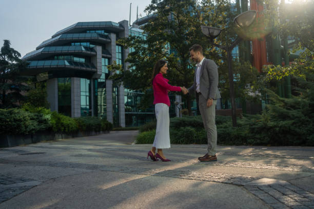 istock Business man and woman exchanging handshake 2171177704