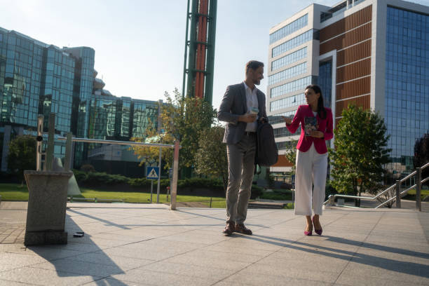 istock Smiling mature business colleagues talking while walking in city 2171177804