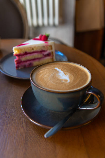 istock Cup of coffee and cake on table in cafe 2171178238