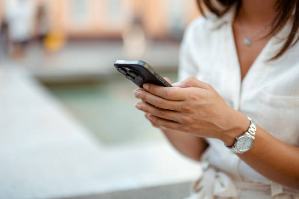 istock Faceless Business Woman Using Mobile Smart Phone Outside 2171179109