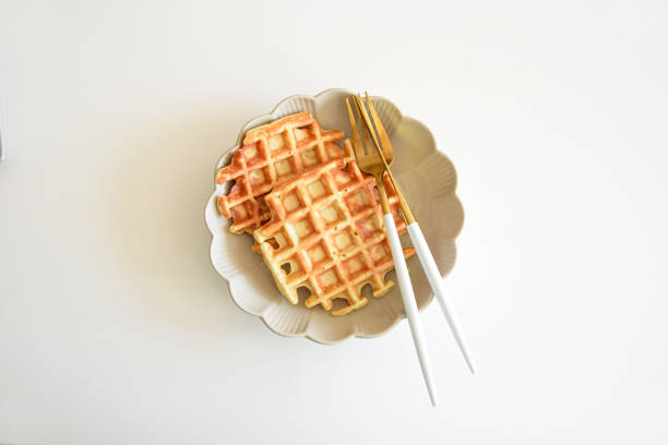 istock Freshly baked apple Belgian waffles on white table 2171179409