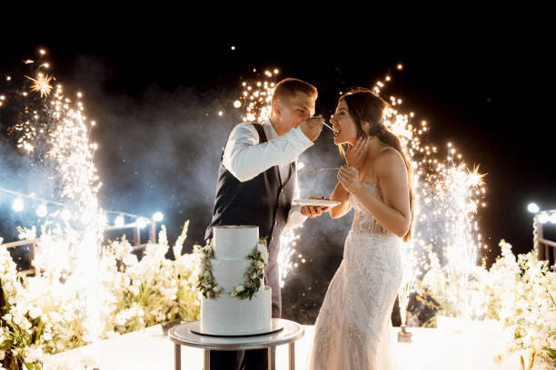 istock newlyweds happily cut and taste the wedding cake 2171180054