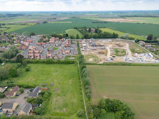 istock Drone aerial view of both a recently completed housing development next to a new, recently started affordable and private home development. 2171180195