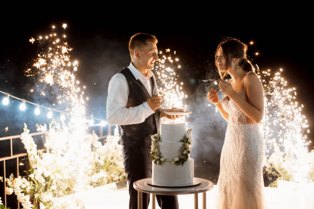 istock newlyweds happily cut and taste the wedding cake 2171180564