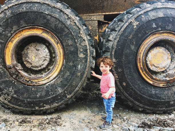 Village boy playing with tire in village.