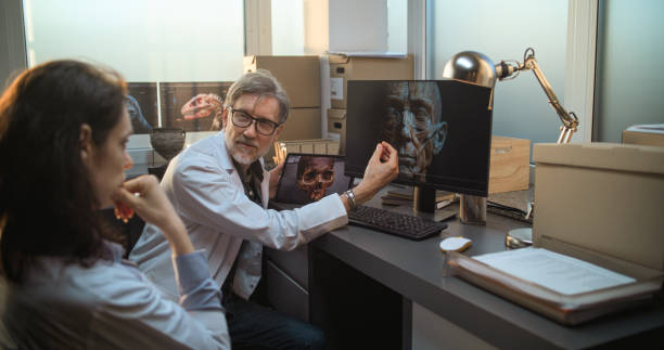 istock Two archaeologists discuss 3D model of human head anatomy displayed on PC tablet computer screens 2171187552