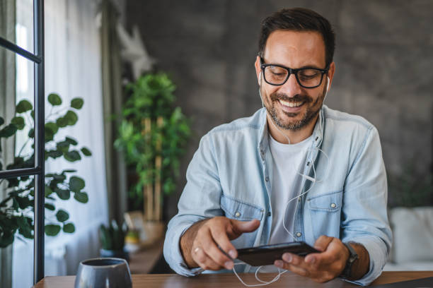 istock Adult man with eyeglasses use and watch a cellphone while sit at home 2171189431