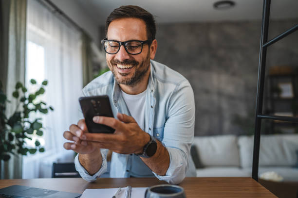 istock Man smile and enjoy while use smart phone at home 2171189604