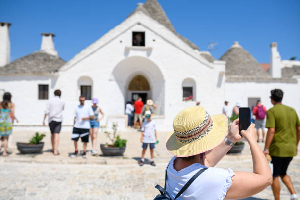 Alberobello, Italy - August 8th, 2024: Tourists in front of \
