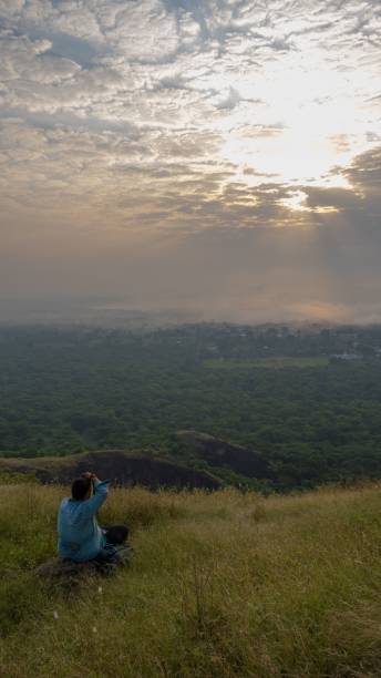 istock Photographer capturing a scenic sunset from a hilltop. 2171190019