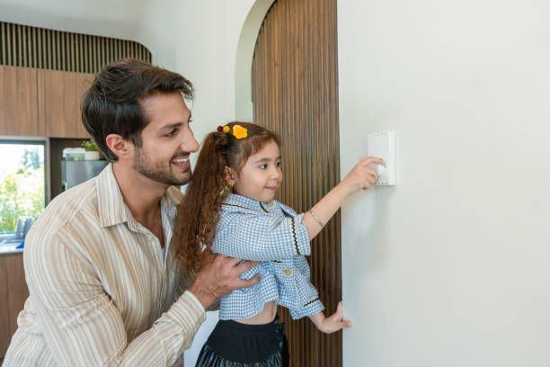 istock A warm and endearing moment between a father and his young daughter, engaging in a daily task together. The father's protective hold and the daughter's active participation in a simple task show a combination of learning, trust, and fun. 2171190761