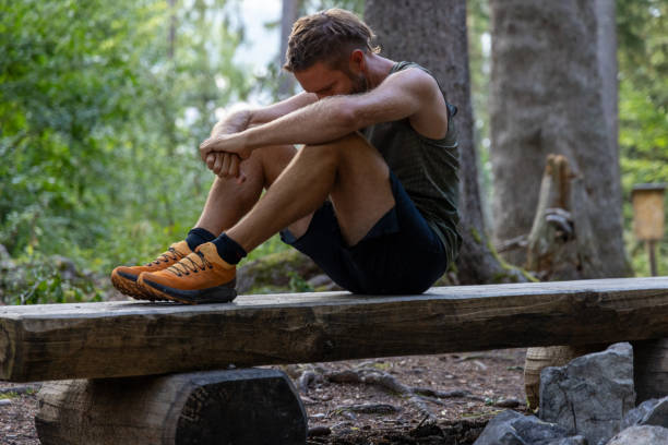 istock Man resting on a wooden bench in the forest after workout 2171195366