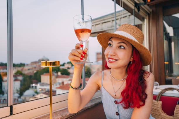 istock A woman elegantly tasting amber wine at a restaurant, savoring its complex flavors and aromas while enjoying a gourmet dining experience 2171195592