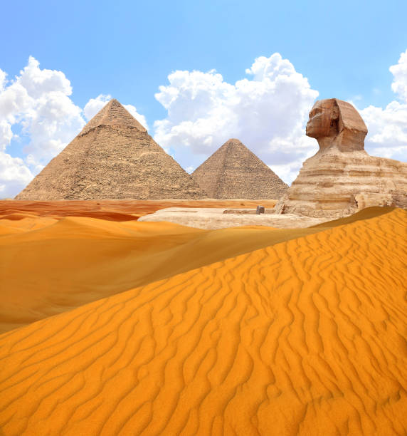 Famous Great Sphinx and pyramids of Chephren and Cheops, Cairo, Egypt. Great Pyramids, ancient statue of Sphinx and beautiful sand dunes, Giza complex (Giza Necropolis)