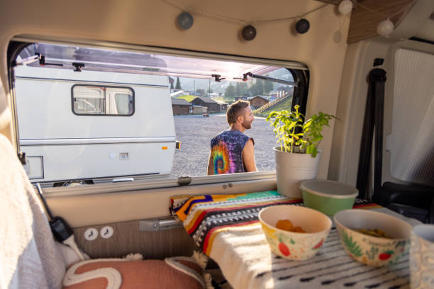 istock Man standing outside camper van in morning light 2171200646