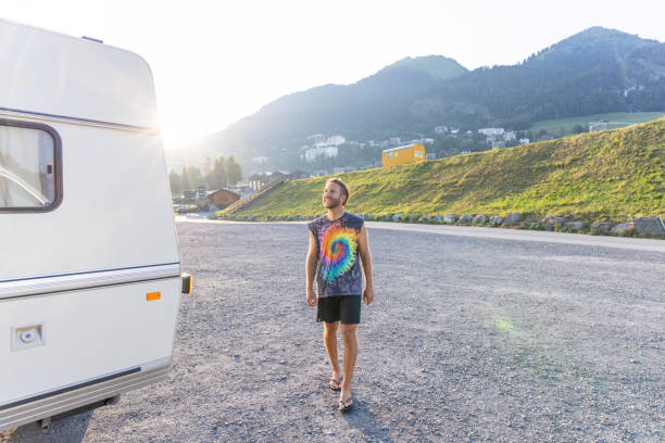 istock Man walking by a retro style camper in the morning 2171200727