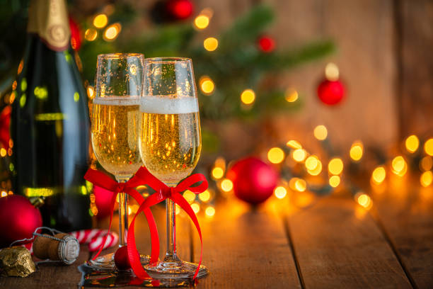 istock Two Champagne glasses on Christmas dining table. Defocused lights at background 2171200803