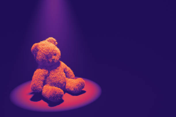 istock A lone teddy bear bathed in a spotlight against a dark background 2171202018