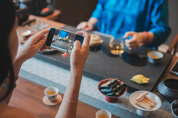 istock Person capturing tea ceremony on phone at a tea house 2171202947