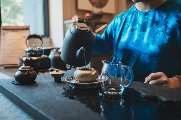 istock Pouring hot water into traditional teapot 2171203196