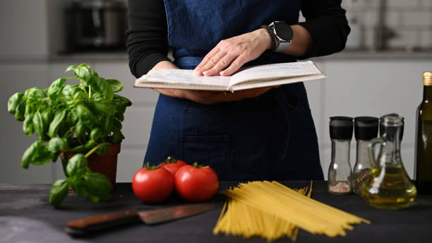 istock Woman In Kitchen Reading Receipt Book In Kitchen 2171204798