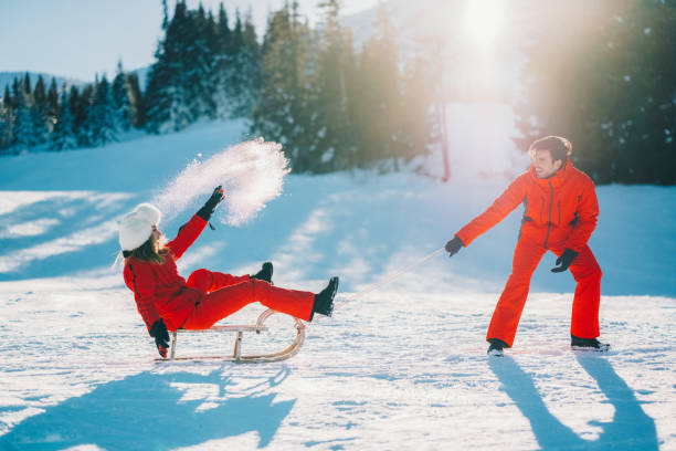 istock Joyful couple sledding on winter holiday 2171204895