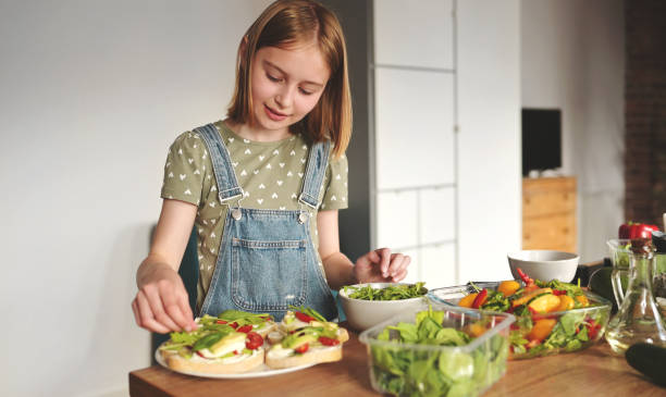 istock Girl with vegetables at kitchen 2171205404