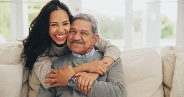 Hug, portrait and smile of old man with daughter on sofa in living room of home for bonding or visit. Face, family or love with happy woman and senior father embracing in apartment together Hug, portrait and smile of old man with daughter on sofa in living room of home for bonding or visit. Face, family or love with happy woman and senior father embracing in apartment together