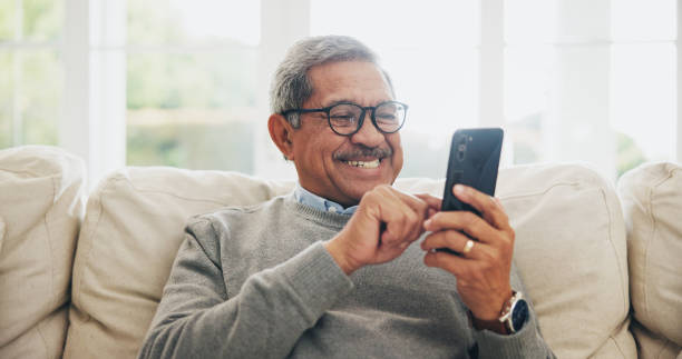 istock Home, senior man and smartphone with typing, internet and message for contact, texting and relax. Mature person, apartment and elderly guy with cellphone, digital app and mobile user with network 2171209502