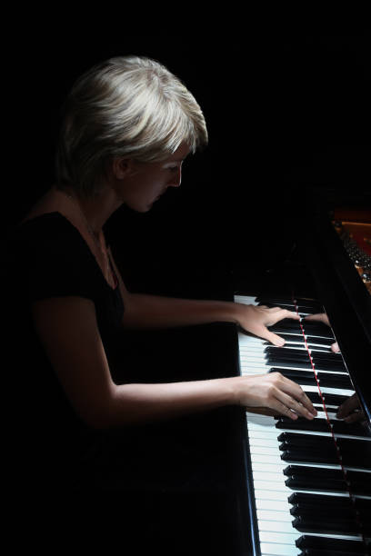istock Woman playing piano pianist player 2171210644