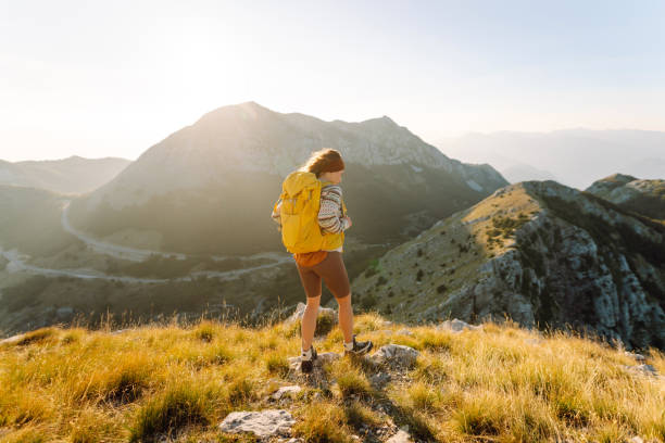 istock A joyful hiker enjoys the breathtaking view from a mountain 2171217143