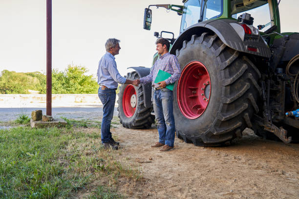 istock A farmer and precision farming expert shake hands while standing inside a barn 2171217265