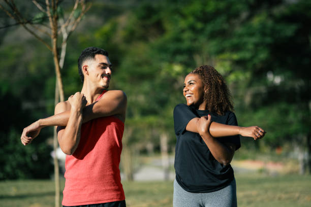 istock Young couple exercising together in a public park 2171230970