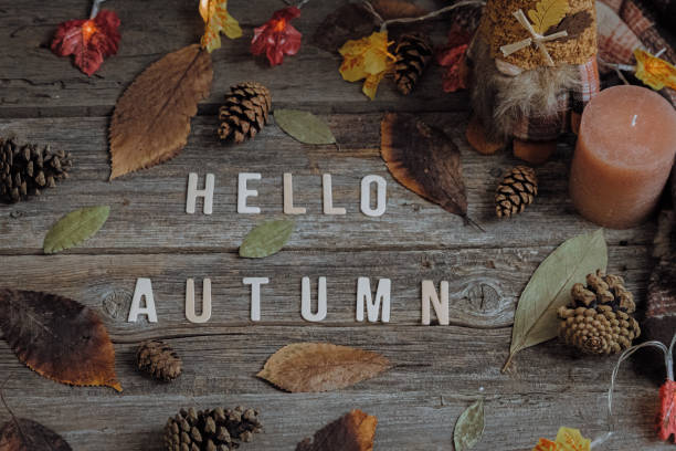 istock A phrase from the letters hello autumn, a candle and a scarf on the table. 2171231653