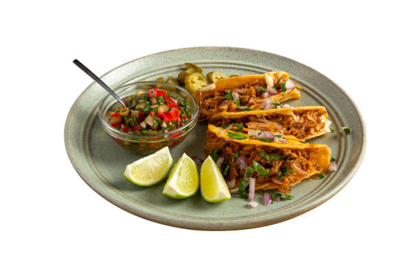 istock Delicious tacos filled with meat served on a plate. 2171234264