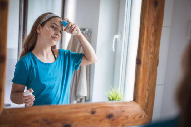 istock Happy girl applying face moisturizer 2171234803