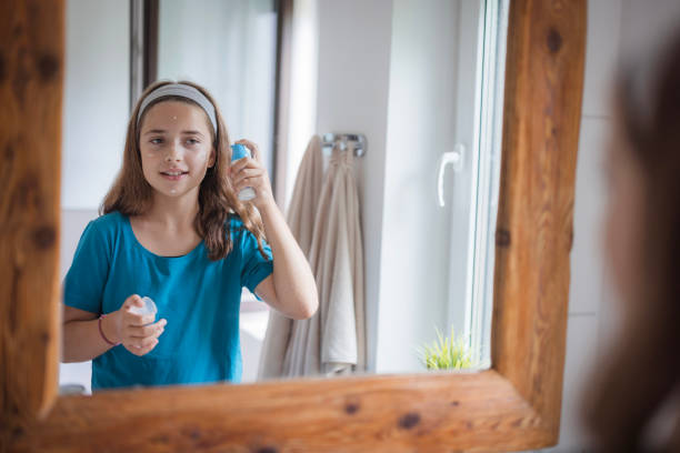 istock Girl putting face cream on her face 2171234832