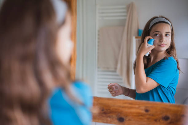 istock Girl putting face cream on her face 2171234843