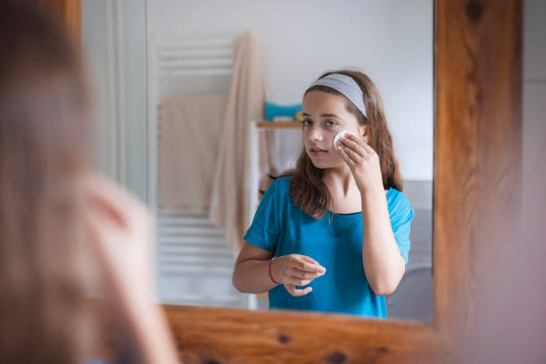 istock Adolescent girl removing make up with a cotton pad 2171234881