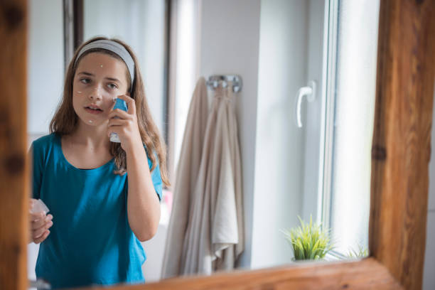istock Girl putting face cream on her face 2171234907