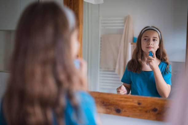 istock Girl putting face cream on her face 2171234981