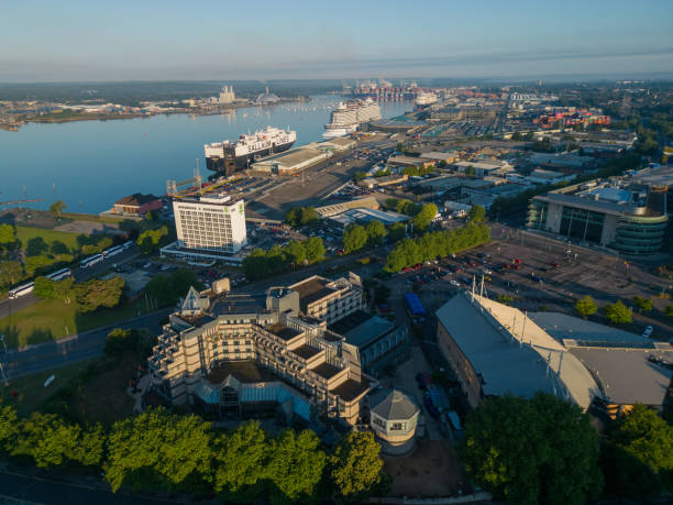 Southampton UK aerial view of business district with hotels, offices and docks at sunrise. Modern architecture and seafront with ferry and cruise ships on a calm sunny morning in summer. Southampton, UK, 08.04.2024