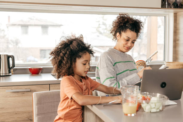 istock Mom and daughter having breakfast in the kitchen 2171238594