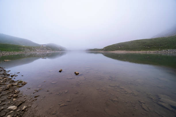 Taisho Pond and Mount Yakedake shrouded in early morning mist, Kamikochi