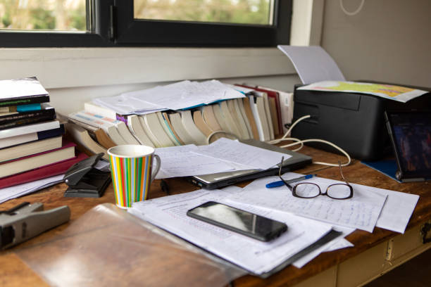 istock Messy desk full of books and papers 2171242349