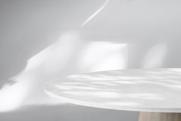 istock Round marble table top with abstract shadow drop on white wall background for mockup product display 2171245812