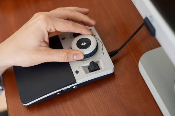istock A woman uses a special magnification device for the visually impaired. 2171247876