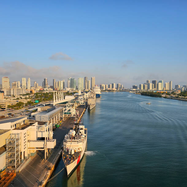Several ships docked in the port with a view of the Miami skyline
