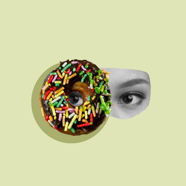 istock A donut with sprinkles on it is shown with a woman's face behind it 2171261521