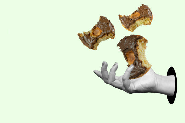 istock A hand holding three bitten donuts with chocolate frosting 2171261720